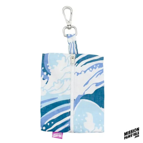 Wave Runner Carry-All is a blue and white patterned fabric pouch featuring a zipper and metal clip, with a small tag that reads "MISSION PAWSIBLE".