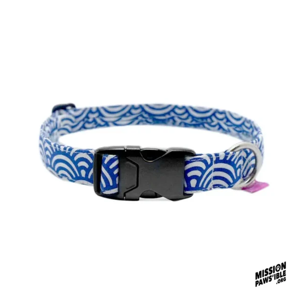 The Rollin In The Deep Collar is a blue and white patterned pet collar with wave-like designs, a black plastic buckle, and a metal ring.