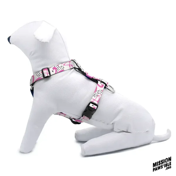 A white mannequin dog is sitting while wearing the Flirty Flamingos Adjustable Harness, which features a pink and black design. The logo "Mission Pawsible" appears in the bottom right corner.