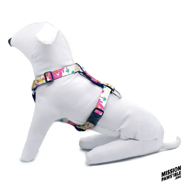 A white dog mannequin is shown sitting while wearing the Mermaids Garden Adjustable Harness, with the "Mission Paws’ible" logo visible in the corner.