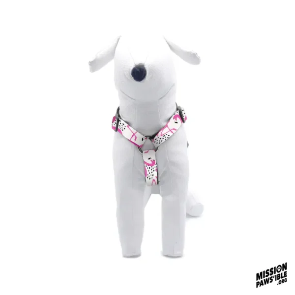 A plush white dog mannequin showcases the Flirty Flamingos Adjustable Harness, featuring a pink and white geometric pattern, against a plain white background.