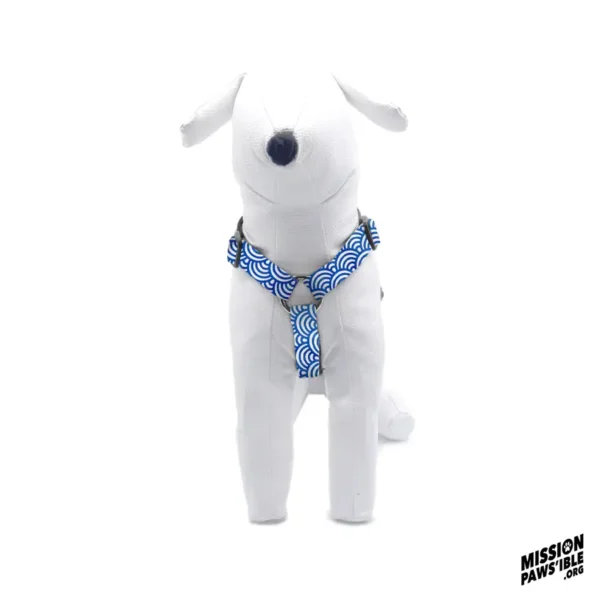 A white dog mannequin wearing the Rollin In The Deep Adjustable Harness with a blue pattern, set against a plain white background. "Mission Paws'ible" logo in the corner.