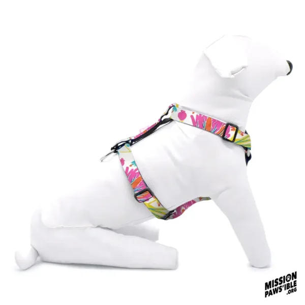 A white mannequin dog is wearing the Mermaids Garden Adjustable Harness, which features abstract patterns in vibrant shades of pink, yellow, and purple.