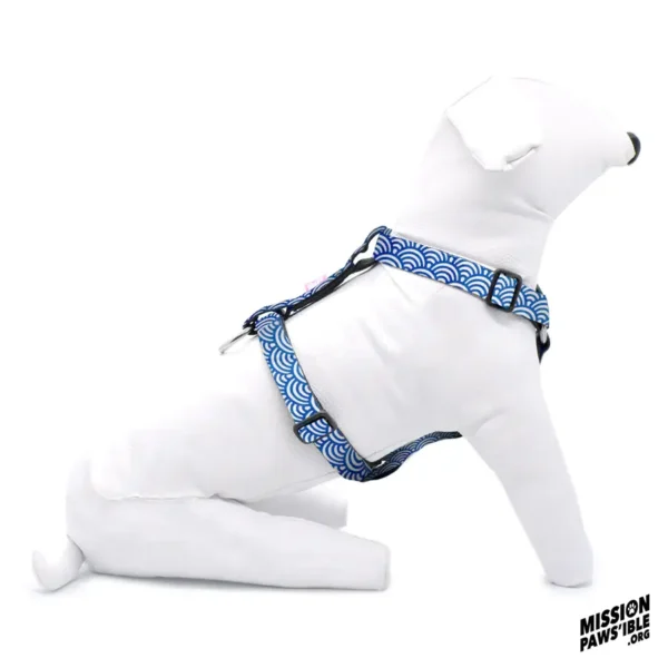 A white dog mannequin sits against a white background, donning a blue patterned "Rollin In The Deep Adjustable Harness." The "Mission Paws'ible" logo is displayed in the corner.