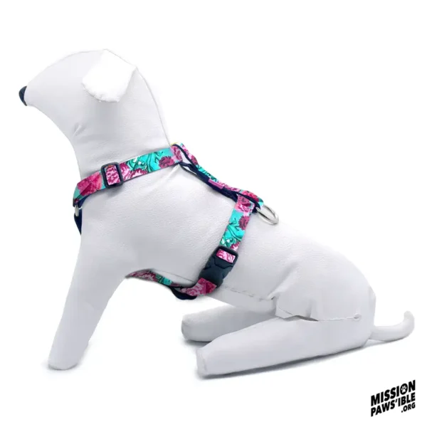 A white dog mannequin sporting a Flower Power Aqua Adjustable Harness sits against a white background, with the Mission Paws'ible logo in the corner.