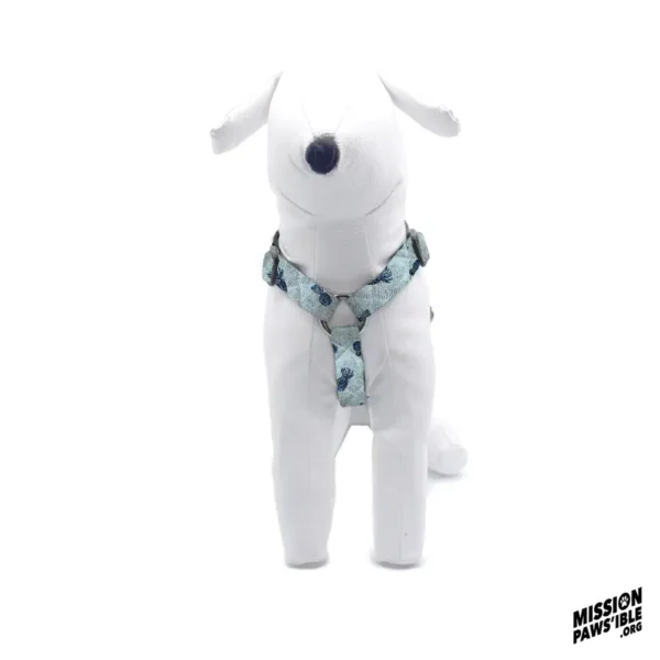 A white dog mannequin wearing a Pineapple Express Blue Adjustable Harness with a floral pattern.