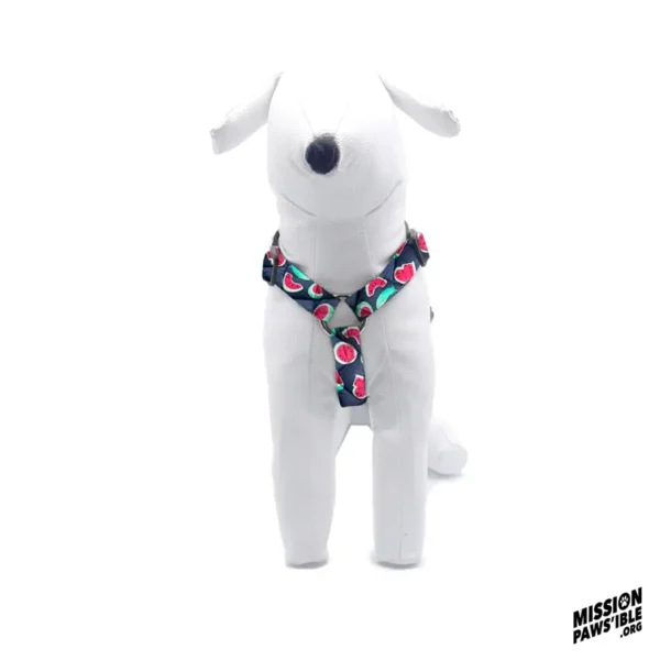 Stuffed white dog wearing a vibrant harness with a floral design, positioned against a plain white background. The logo in the corner reads "Mission Pawsible.