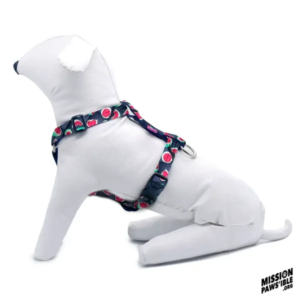 A stuffed dog wearing a vibrant Flower Power Yellow Adjustable Harness with watermelon patterns, sitting against a white background. In the corner is the logo "Mission Pawsible.