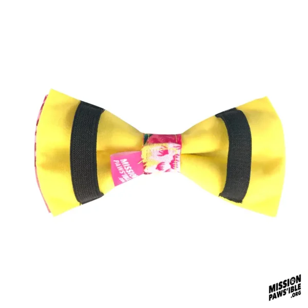 Flower Power Yellow Bow Tie featuring black stripes and a vibrant center detail. The logo in the bottom right corner reads "Mission Pawsible.