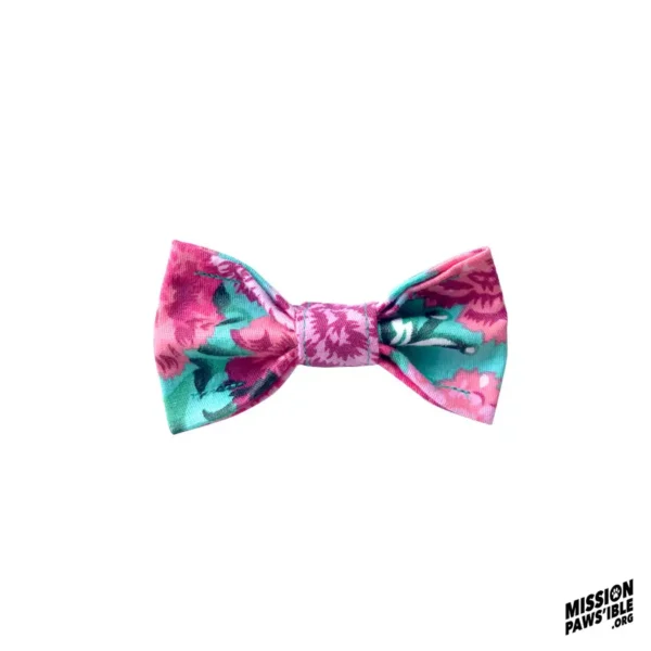 Floral bow tie featuring shades of pink and teal against a white background, with "Mission Paws'ible" text in the corner. Product Name: Flower Power Aqua Bow Tie.