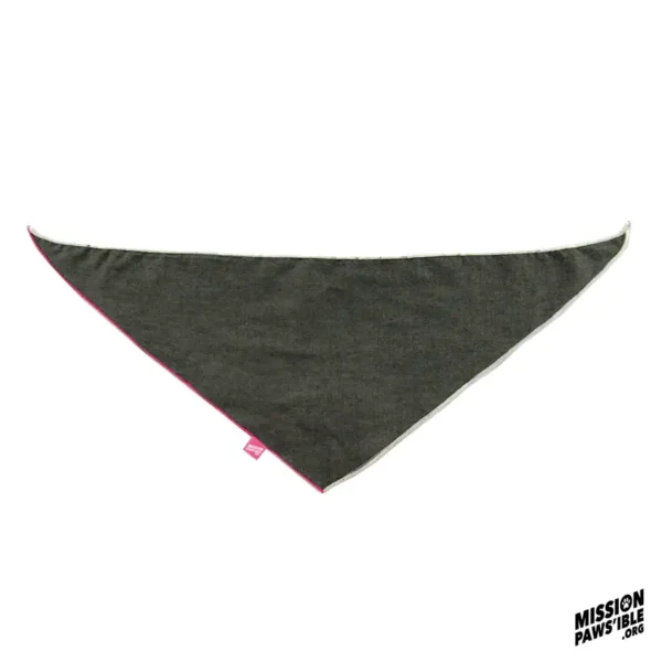 An Onyx Reversible Bandana, triangular and crafted from dark fabric, is accented by a pink edge and features a small tag alongside the "Mission Pawsible" logo in the bottom corner.