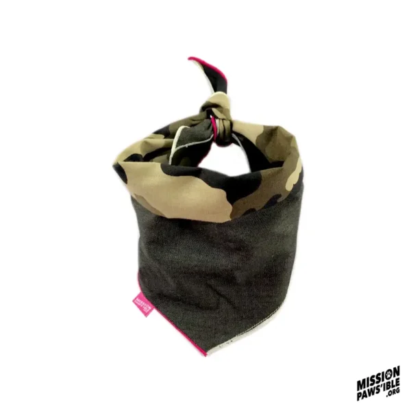 The Onyx Reversible Bandana features a camouflage pattern with a top knot and a small pink tag on the side, along with the "Mission Paws'ible" logo in the corner.