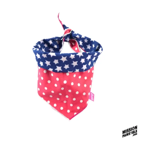 The Star Spangle Reversible Bandana features a red and white polka dot pattern on the bottom half, a blue and white star pattern along the top edge, and includes the "Mission Paws'ible" logo in the corner.