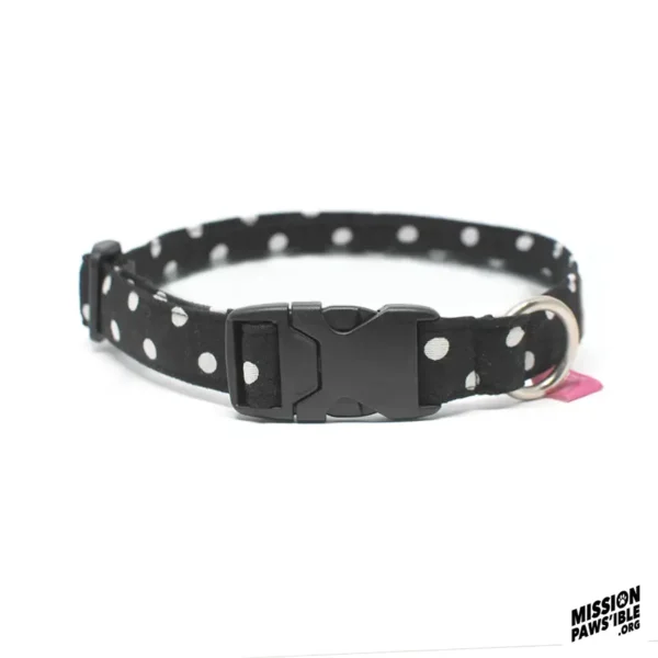 Introducing the Polka Face Black Collar: a stylish black collar adorned with white polka dots, featuring a secure plastic buckle and sturdy metal ring.