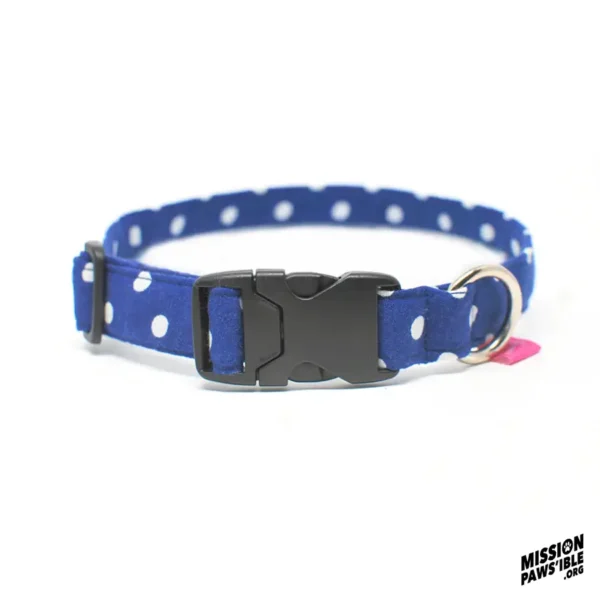 Introducing the Polka Face Blue Collar: a stylish blue polka dot pet collar featuring a black plastic buckle, a metal ring, and the Mission Paws'ible logo in the corner.