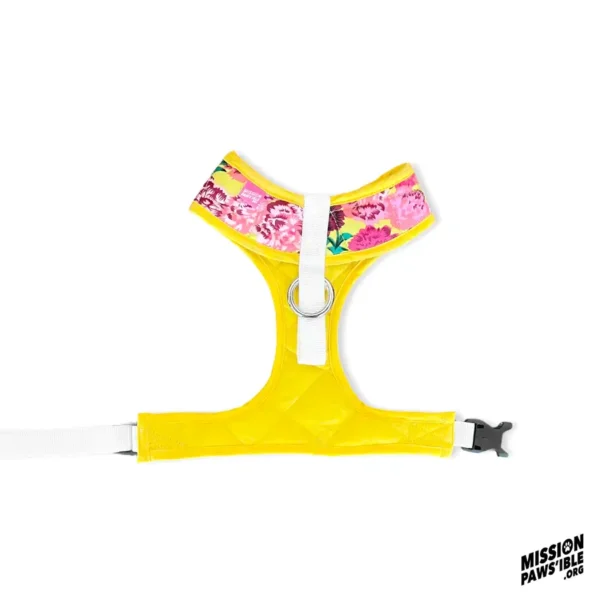 Flower Power Yellow Chest Harness featuring a pink floral pattern on top, equipped with a black buckle on one side, and showcasing the Mission Paws'ible logo in the bottom right corner.